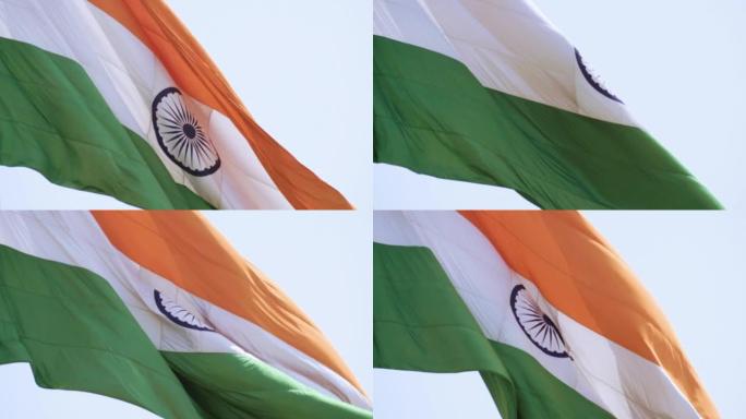 印度国旗在蓝天下高高飘扬，印度国旗飘扬，印度国旗在独立日和印度共和国日，倾斜拍摄，挥舞印度国旗，飘扬