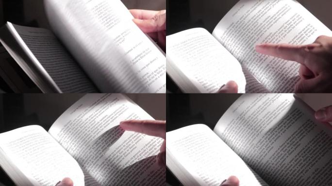 快速翻动西班牙书籍的页面，并用手指指向文字