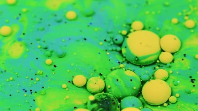油墨气泡彩色流体混合霓虹绿色黄色