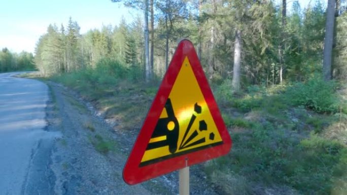 A road sign warning of loose stone chippings on th