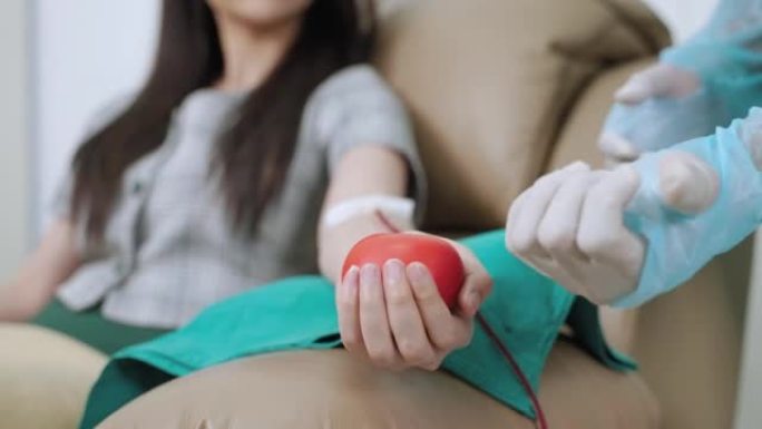 医生向献血者解释如何挤压更好的血液流动，志愿服务，捐赠，健康和药物以及血库