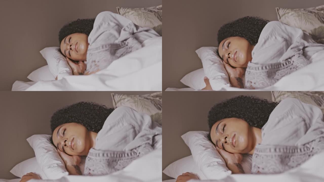 疲惫的年轻女子独自在家睡觉。一位女性只能睡个好觉，并在枕头上休息并躺在毯子下做美梦