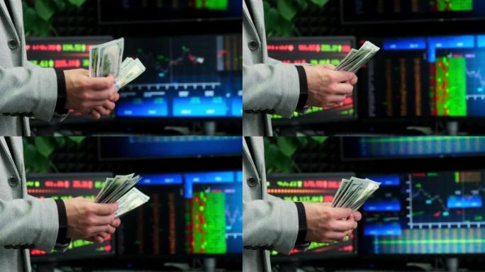 把钱从手转移到手之间。一位商人在股票背景下交出资金的特写镜头。成功交易的概念。现金转移概念。
