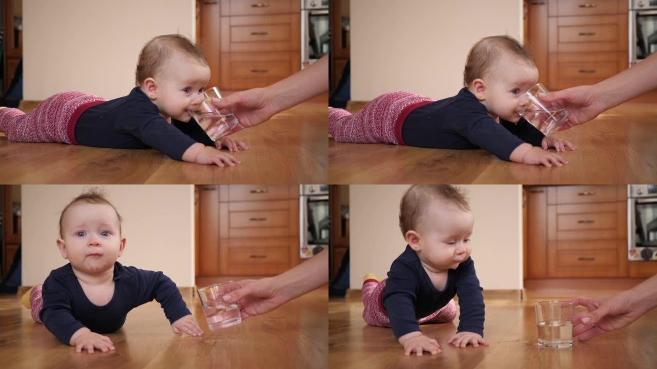 母亲给婴儿一杯水，孩子躺在家里的地板上喝