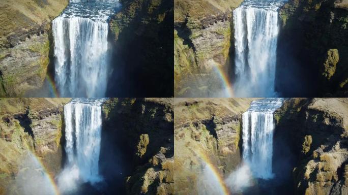 冰岛强大瀑布的史诗般的回撤镜头，水冲下高高的悬崖