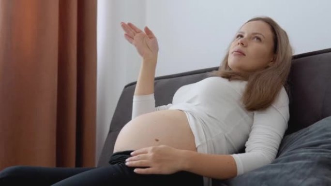 怀孕中期皮肤白皙的孕妇感到窒息
