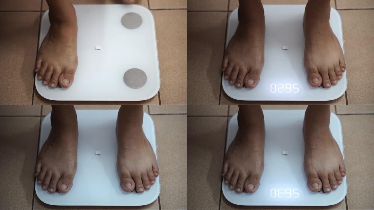 女人在数字秤上检查自己的体重