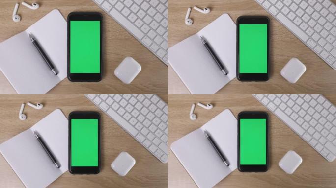 智能手机样机桌上的绿色屏幕