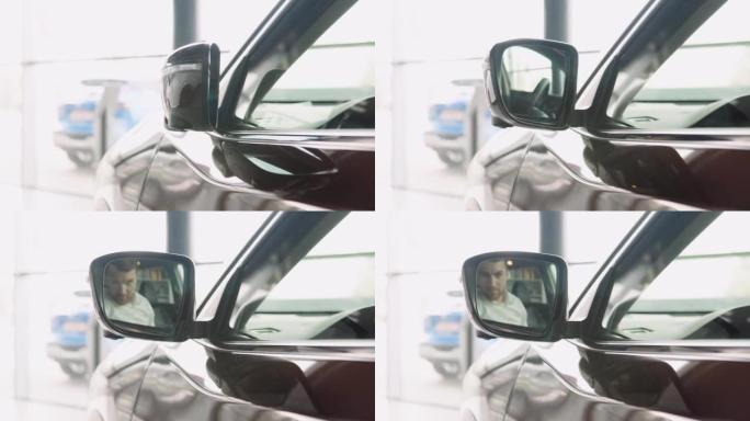 在经销商陈列室的一辆著名的棕色汽车上展开带有内置转向信号灯的外后视镜