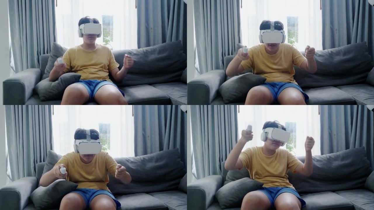 亚洲男孩玩游戏由虚拟现实男孩在沙发上靠近窗户在家里，现代生活理念。