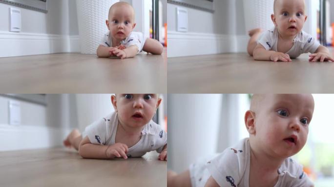 可爱的婴儿婴儿看相机，微笑，试图爬行，学习爬行