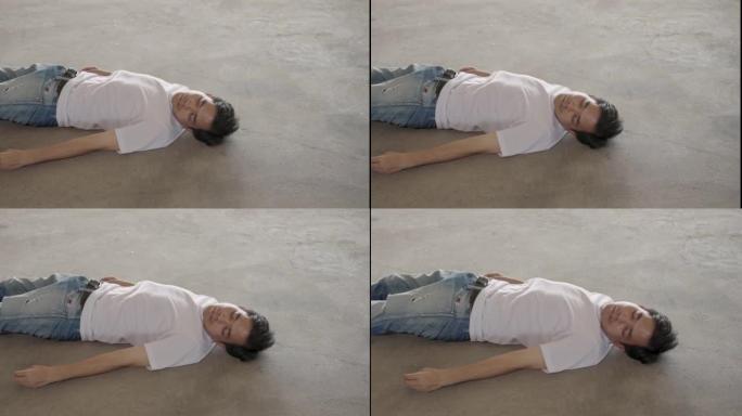 由于酷热，中暑，全球变暖，二氧化碳排放，男子躺在水泥地板上失去知觉。