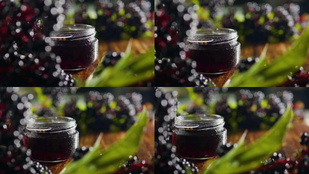 软焦点天然黑色接骨木浆果在木桌上，红色鲜榨果汁从浆果在罐子里。浆果顺势疗法药物