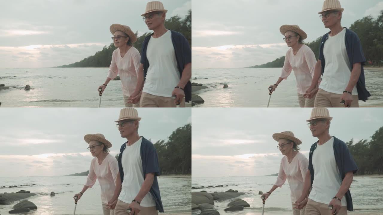 4k视频片段，一对幸福的高级夫妇在夏季日落时在海滩上浪漫的假期中手牵着手拥抱