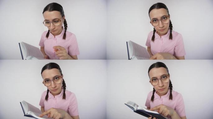 书呆子的学生女孩用手指指着教科书