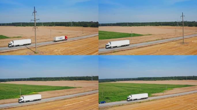 白色卡车穿过农田。收获季节在田间作业的农业机械。顶视图。