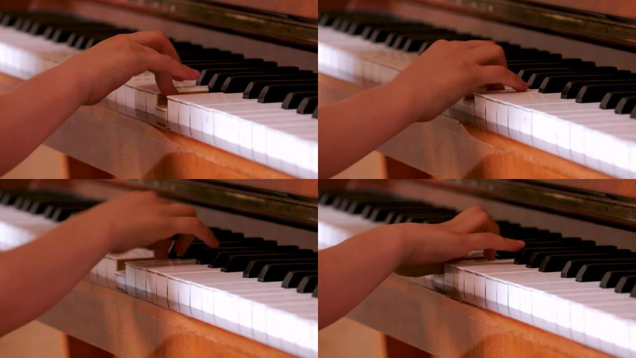 手指年轻钢琴家的右手在钢琴的白色琴键上演奏练习，音乐教育