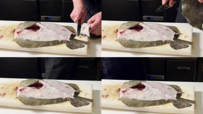 大菱鲆鱼在厨房里被厨师清洗，然后放入烤箱，为餐厅的顾客做准备
