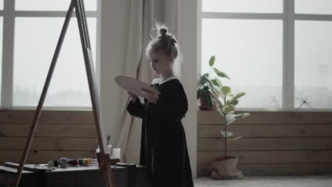 Girl painting a picture with brushes