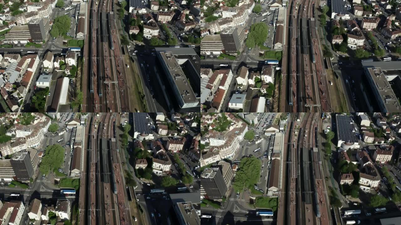 城市火车站铁路路线无人机视图。旅客列车到达车站。