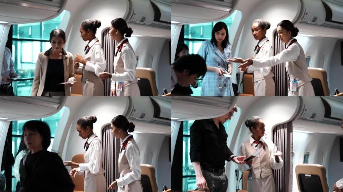 2名穿着制服的年轻漂亮的空姐站在飞机入口处，为登机前检查座位登机牌的亚洲乘客提供服务。