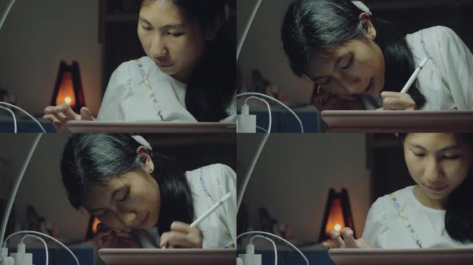 快乐的亚洲女孩使用数字平板电脑和铅笔，同时做家庭作业和与朋友在餐桌上进行视频通话，生活方式理念。