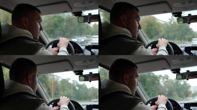 白人成年男子在高速公路上开车，侧视的特写镜头。后视图。双手在方向盘上的男性在城市驾驶车辆。旅行，汽车