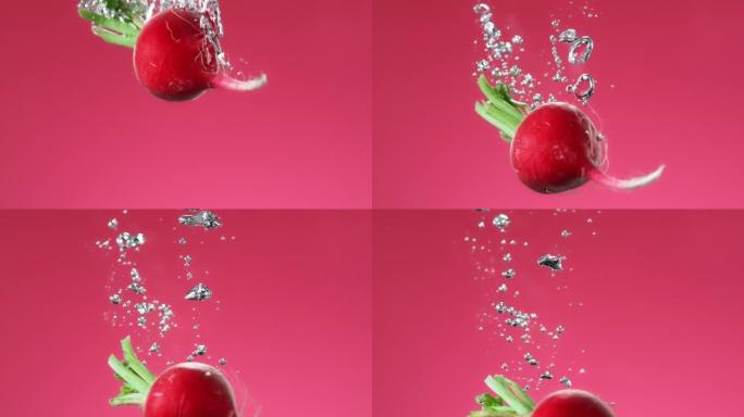 萝卜掉入水中，在粉红色背景上慢动作制造气泡