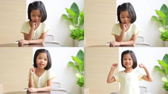 亚洲5岁儿童的肖像，并收集头发并将手放在下巴上并做出思考的姿势，她是幸福，青春的光辉，教育理念