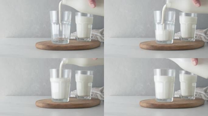 将酸奶或开菲尔倒入玻璃杯中。装有开菲尔或酸牛奶的玻璃杯。乳制品概念