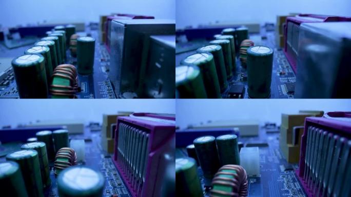 计算机主板微电路，芯片、插槽、电容器和处理器在蓝光下。主板电脑电路关闭。PC主板上电子元件的详细信息