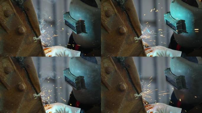 4k亚洲人焊机在建筑厂的焊接机上工作。