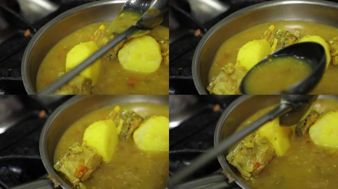 男人的手做饭，在煎锅里炖土豆和鱼。倒入酱汁。印度语、阿拉伯语、菜肴。