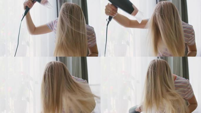 一名年轻女子用电吹风吹干长发。美容和护发的概念