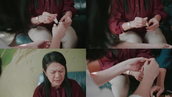 活跃的高级女性试图制作工艺纸花，在制作心皮上放胶水。