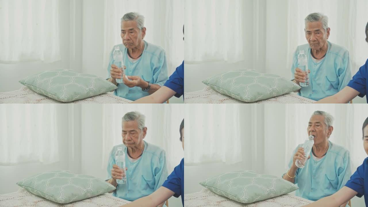 亚洲老人厨房喝水，健康活跃的老人
