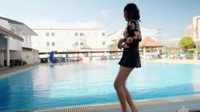 亚洲女孩在室外游泳池附近游泳前热身，激活生活方式概念。