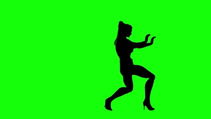 女孩剪影在绿色屏幕上表演超能力移动