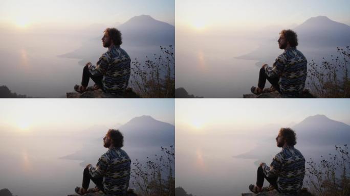 日落时分，坐在危地马拉阿蒂特兰湖背景上的人