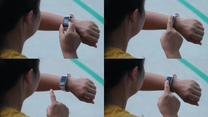 一个女跑步者计算智能手表上燃烧的卡路里的特写镜头。一名年轻运动员在户外练习时使用智能手表检查结果。