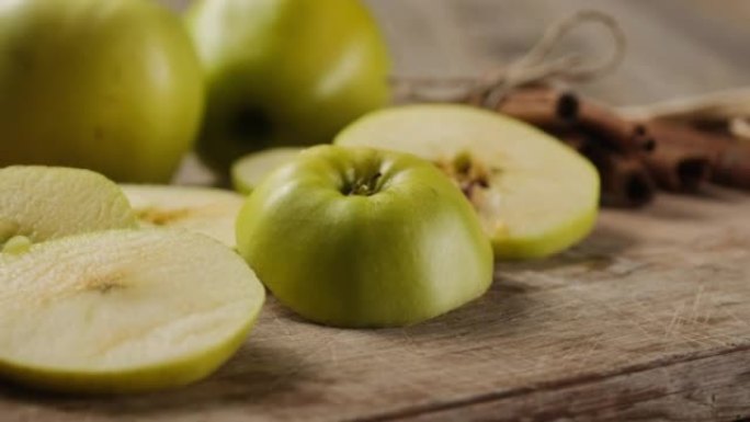 Apple slices next to cinnamon sticks