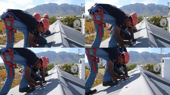 在房屋屋顶上安装太阳能电池板的工人团队