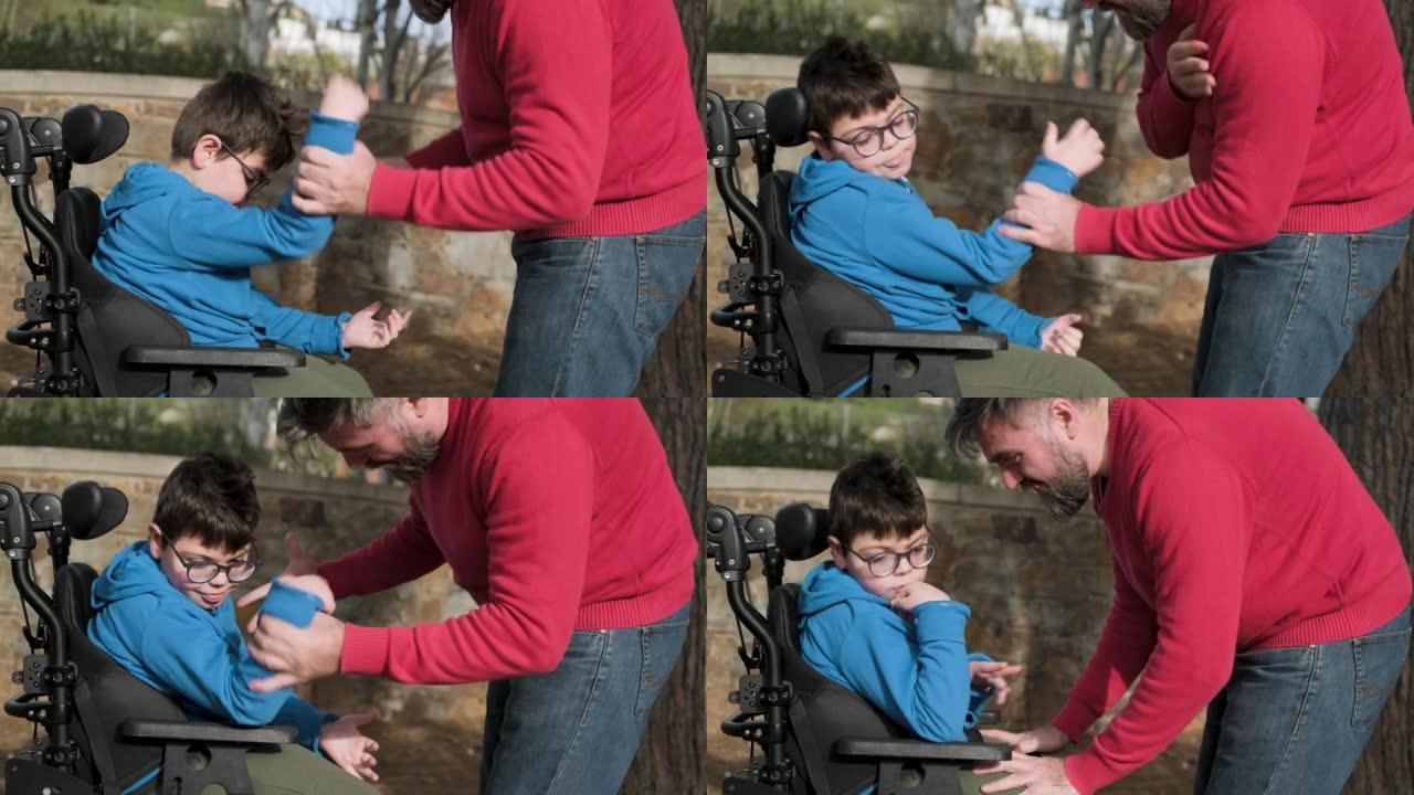 坐在轮椅上四肢瘫痪的小男孩在户外玩耍时享受与父亲的时光。