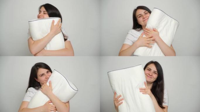 一名妇女抱着她最喜欢的矫形白色枕头，看着镜头微笑