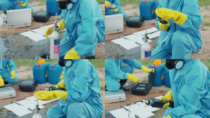 污染控制小组身穿防护服，戴着口罩，在工厂附近清理油污