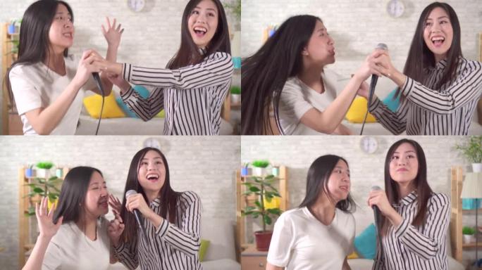 两名年轻亚洲女子在客厅家中唱卡拉ok