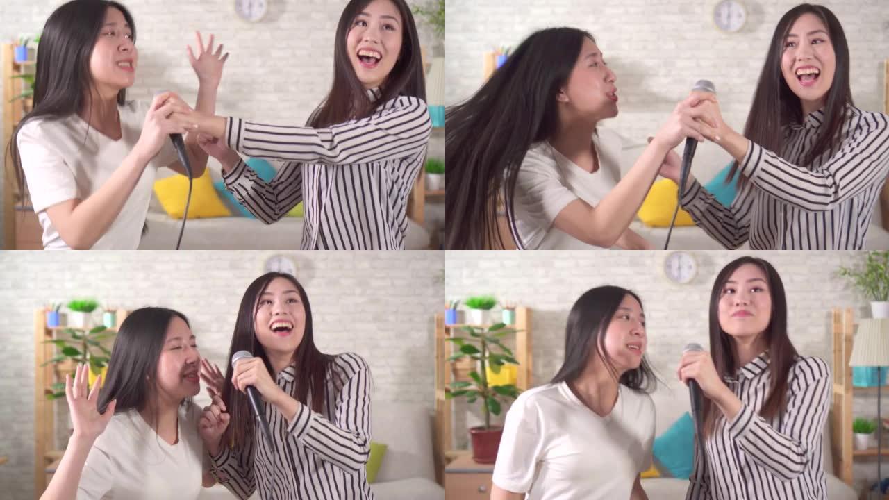 两名年轻亚洲女子在客厅家中唱卡拉ok