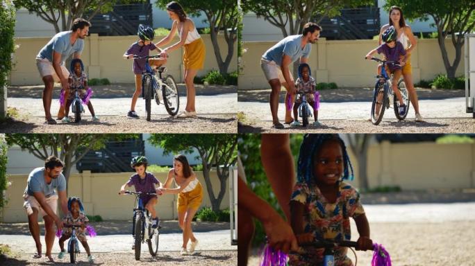 父母帮助孩子在阳光明媚的车道上骑自行车