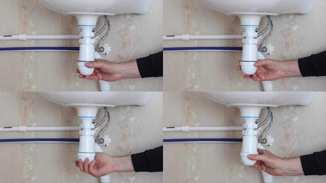 安装水槽下的排水管，水管工拧在虹吸管盖上。