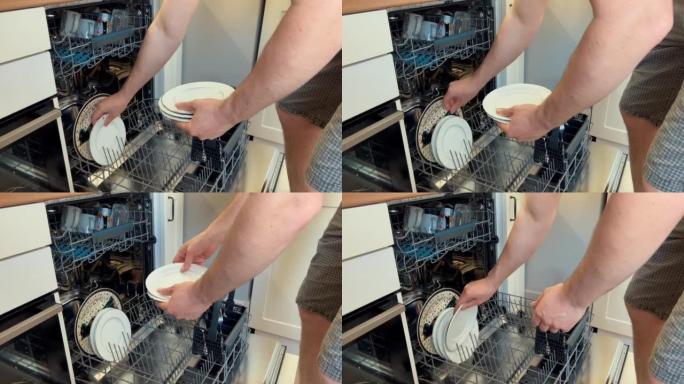 男子将碗碟装入洗碗机